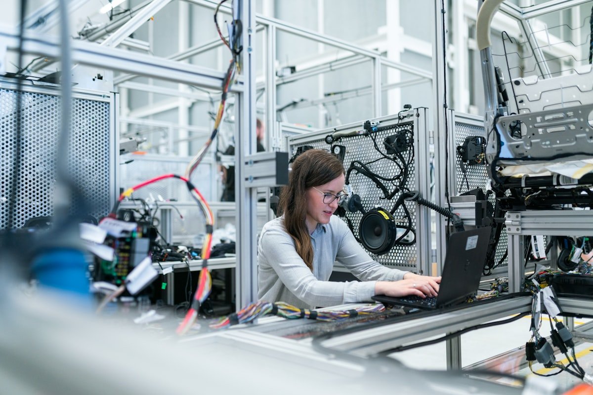 Engineers and technologists collaborating in high-tech laboratory environment with robotics and computers
